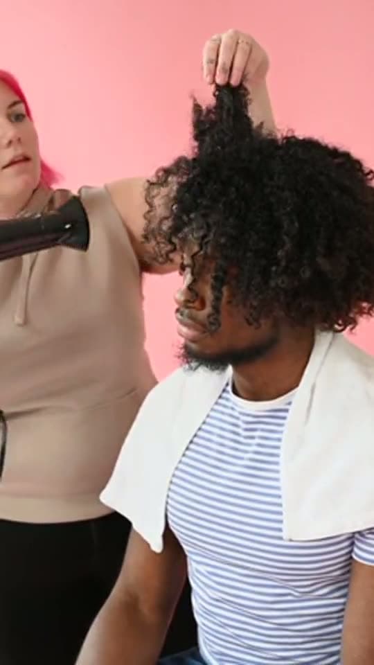 A stylist blow-drying hair, the background of a salons and barbers sign-in page